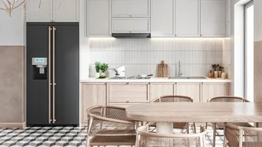 Modern kitchen with light wood cabinets, black fridge, wooden dining table, and hexagonal tile flooring.