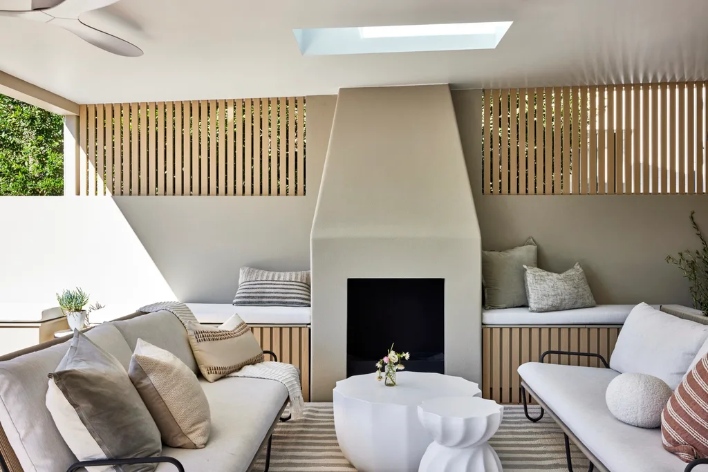 Californian bungalow renovation all weather outdoor living with neutral sofa and fireplace
