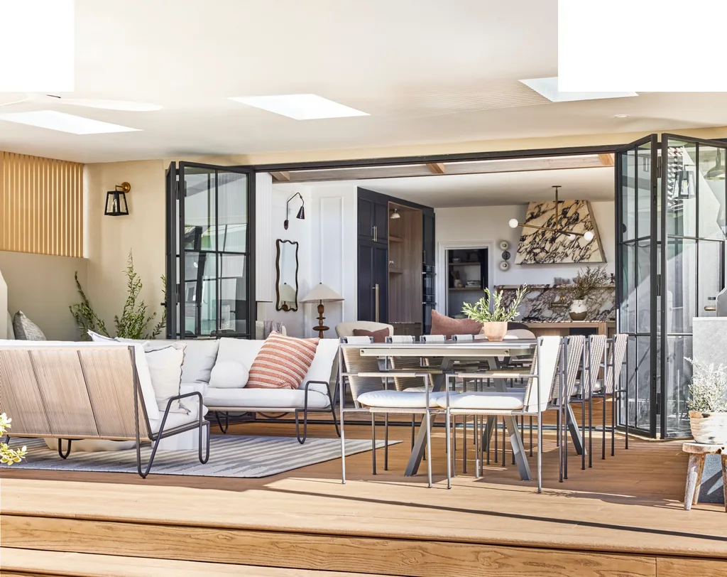 Californian bungalow renovation deck with outdoor chairs, dining and sofa plus steel doors