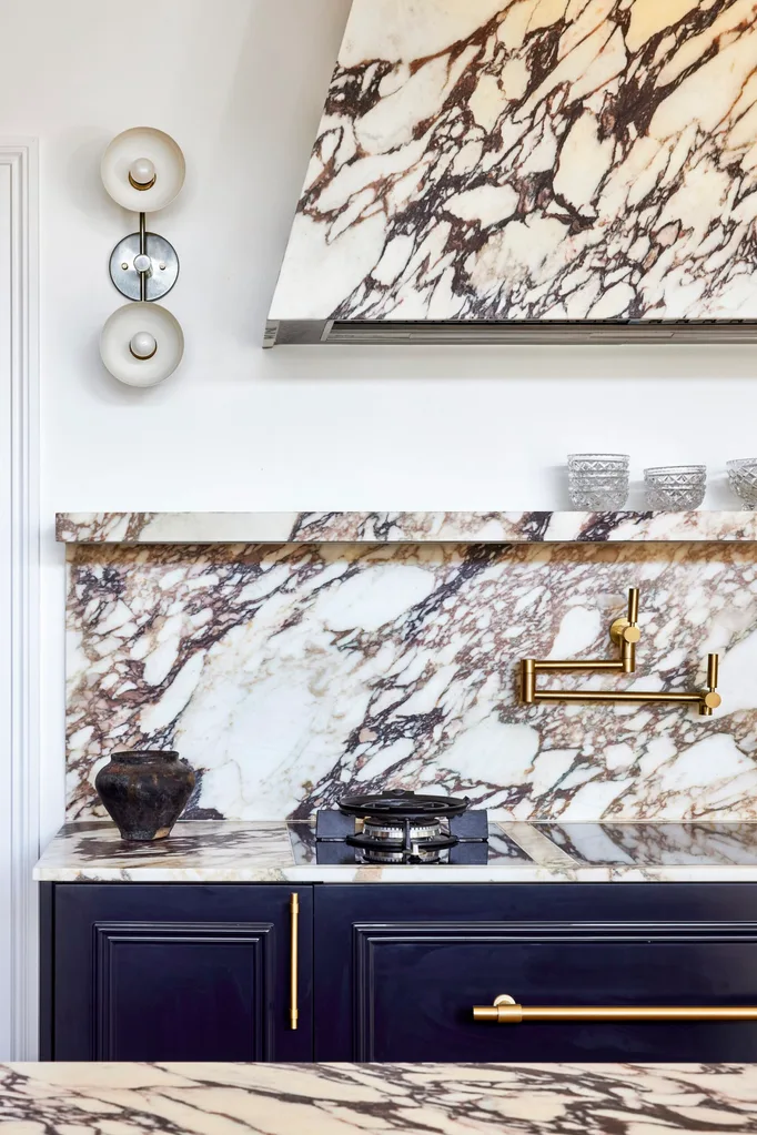 Californian bungalow renovation kitchen with calacatta viola marble rangehood and splashback with navy cabinets and brass hardware