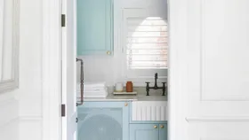 Doorway to a white and blue laundry.