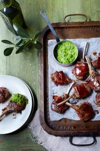 Lamb cutlets with pea puree on a tray