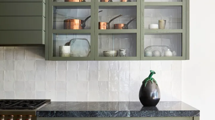 A modern farmhouse style kitchen with greige cabinetry and drawers.
