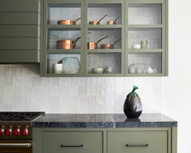 A modern farmhouse style kitchen with greige cabinetry and drawers.