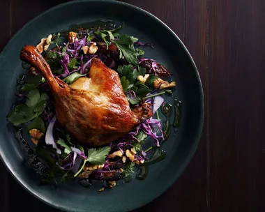 Two servings of winter slaw with red cabbage, blistered dates and confit duck.