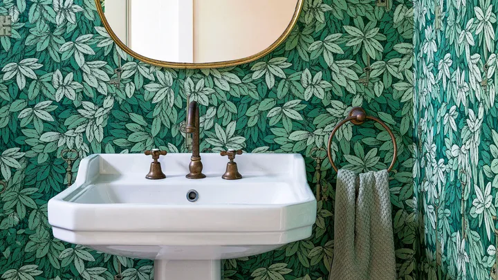 Green leaf wallpapered powder room ideas with pedestal basin