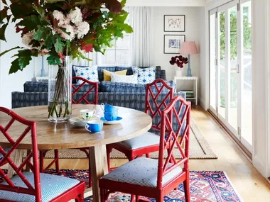Dining and living area with pops of red and blue.