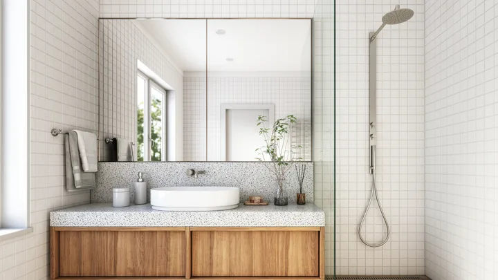 image of a white bathroom with natural wooden cabinets and a rain shower
